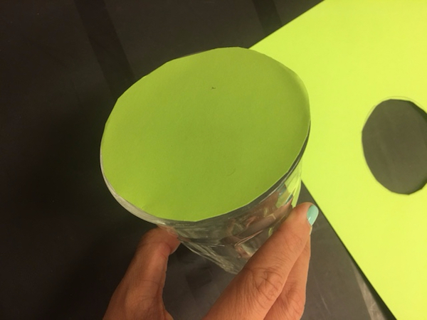 Attach the paper circle to the opening of your glass.