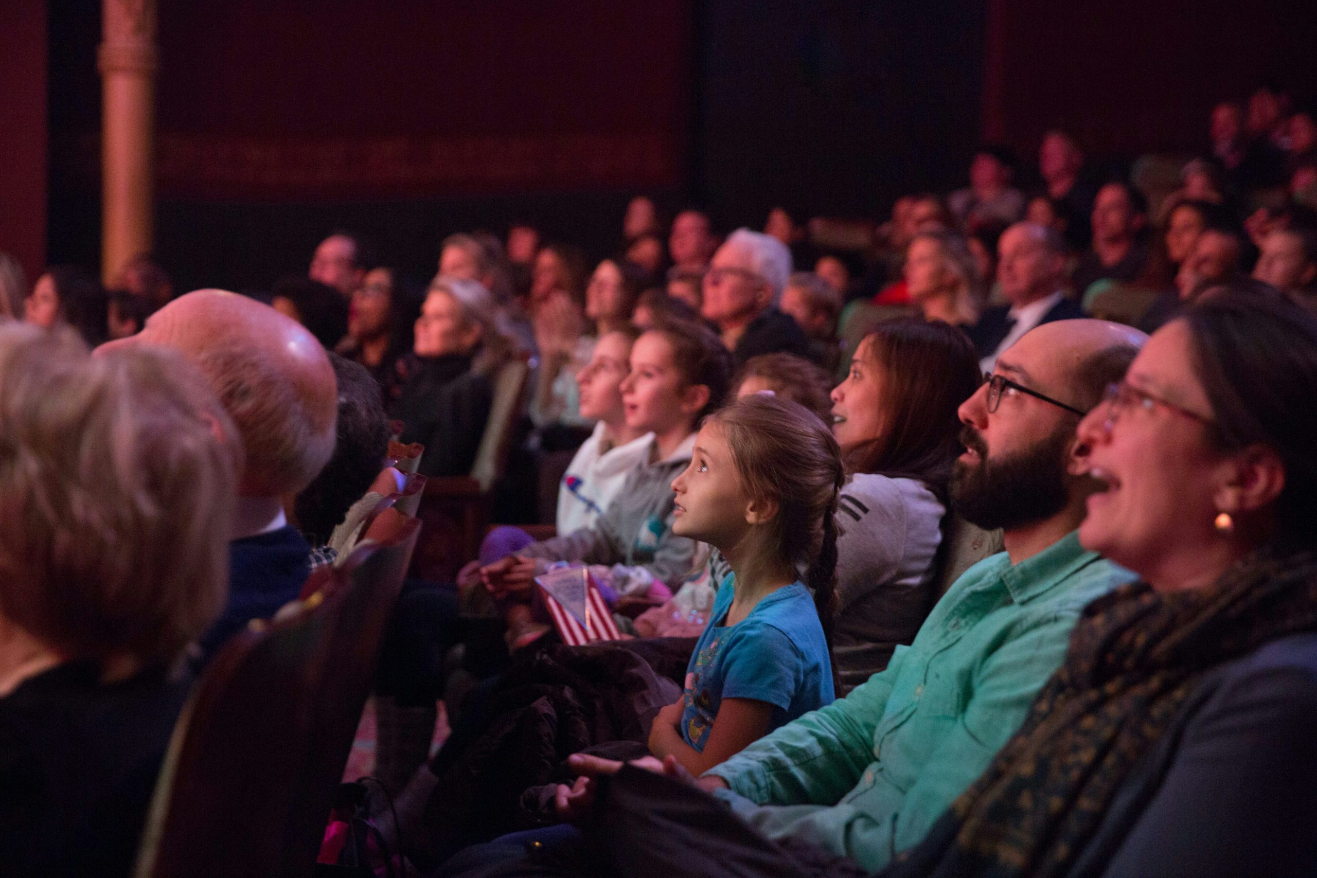 Families in the New Victory Theater watch a show.