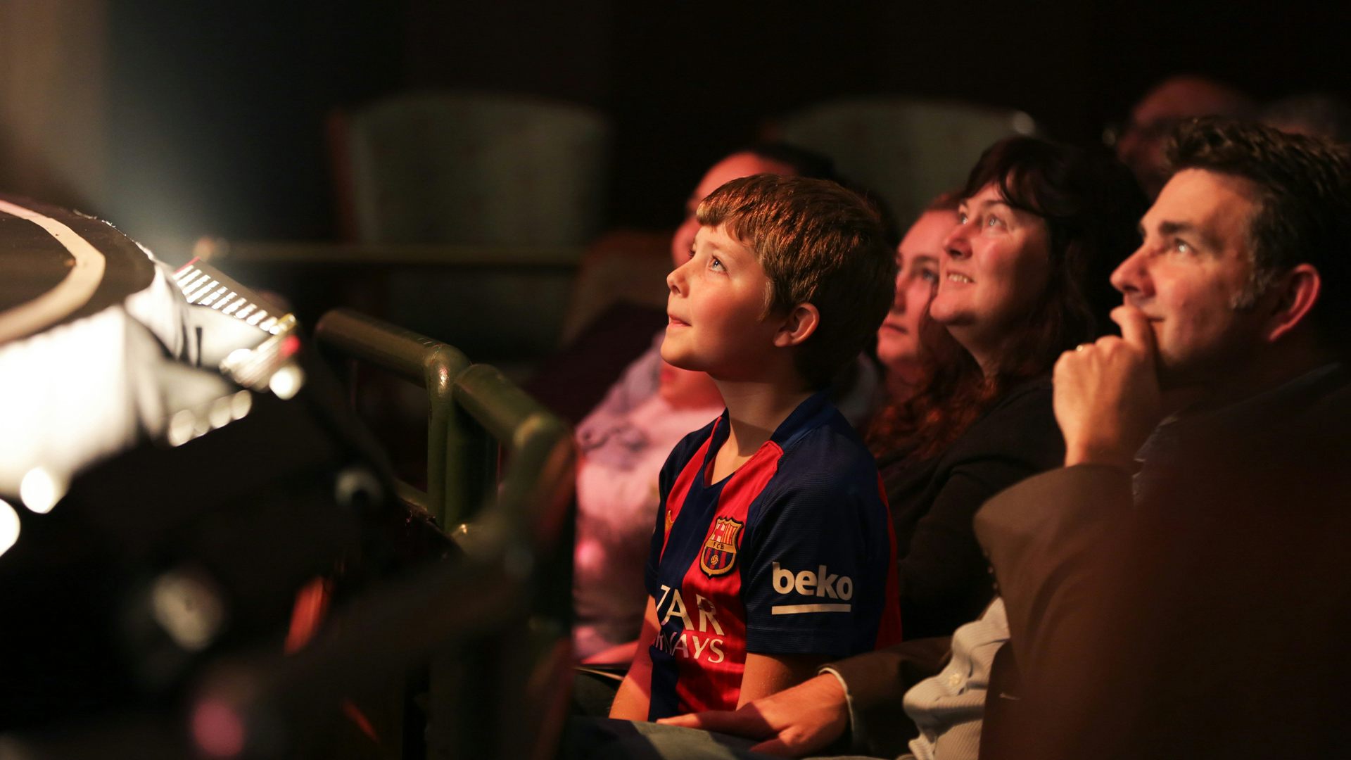 Young boy and family watching a performance.