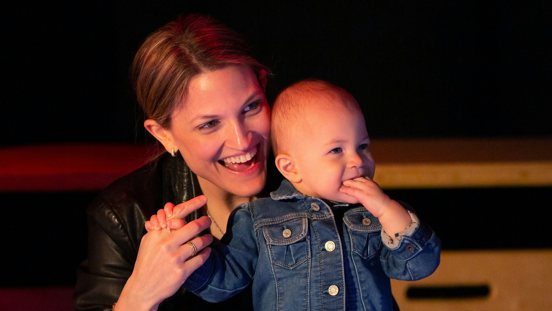 A mom and her young toddler watch a performance with shear joy.
