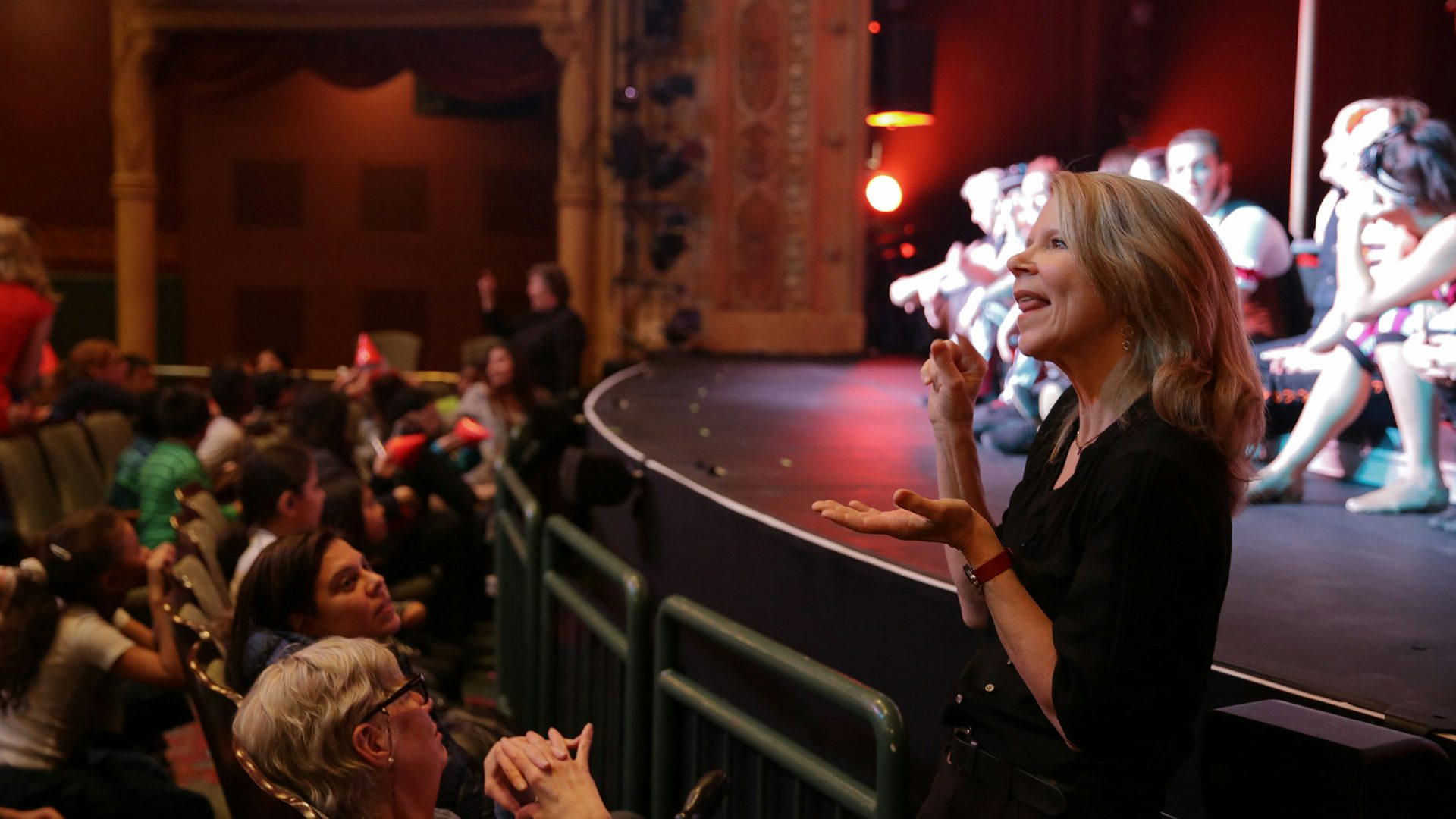 An ASL interpreter signs a post-show talk-back inside the New Victory Theater.