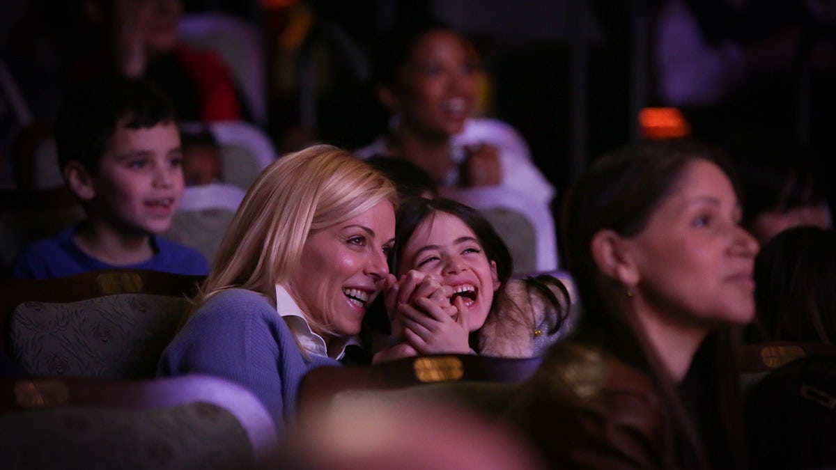 Woman and girl laughing in audience