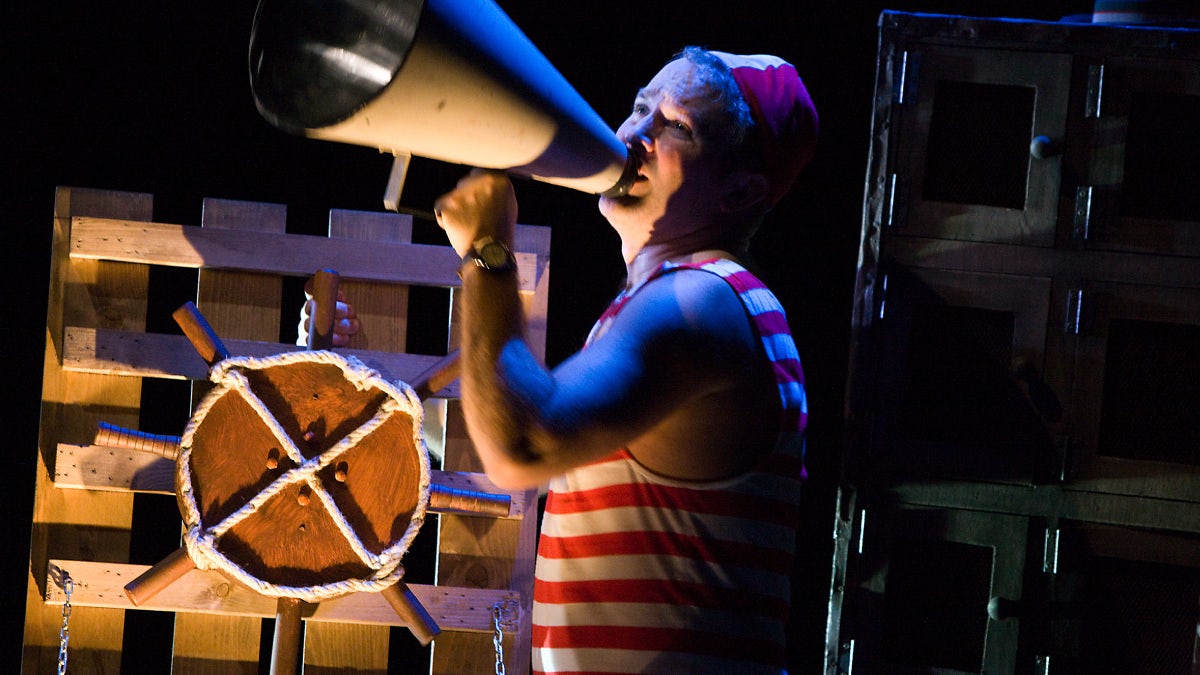 An actor uses a megaphone in a scene from The Girl Who Forgot to Sing Badly.