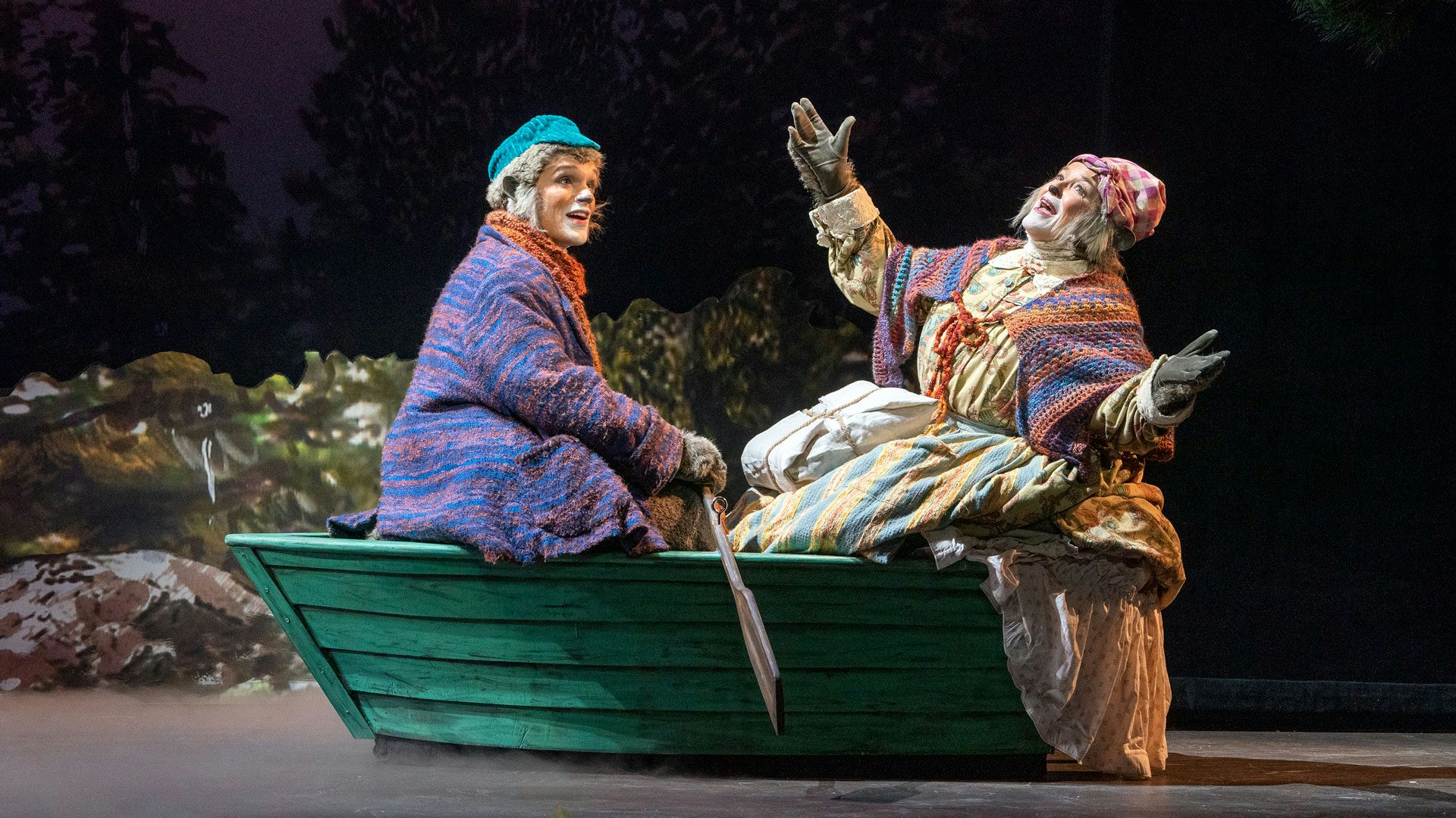 Colin Trudell as Emmet Otter and Cass Morgan as Ma Otter in a rowboat.