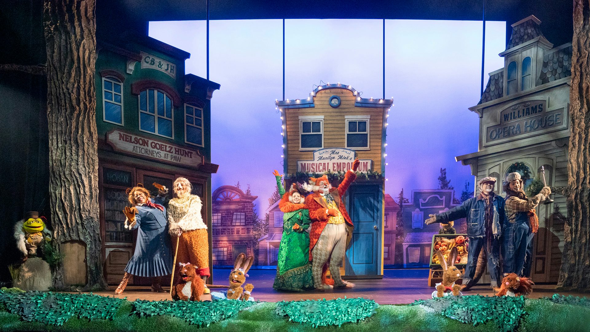 The cast and critters of Jim Henson's Emmet Otter's Jug-band Christmas with Waterville town buildings.