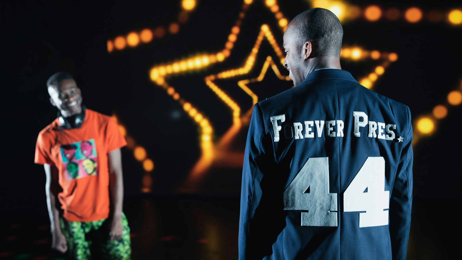 The back of a man's jacket reads, "Forever Pres. 44"