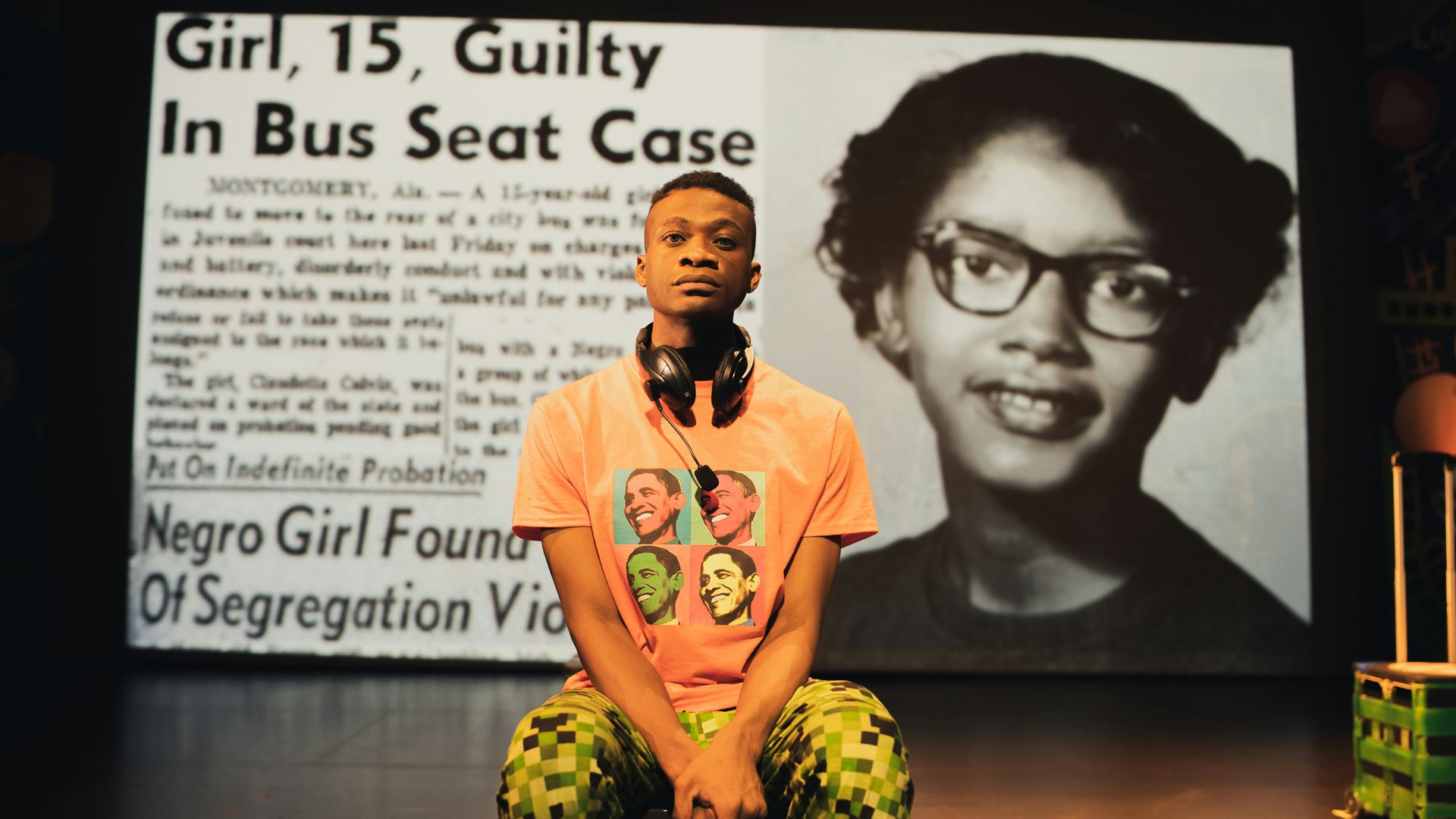 Jabari sits stoically, looking front. Behind him, a newspaper headline says, "Girl, 15, Guilty in Bus Seat Case."