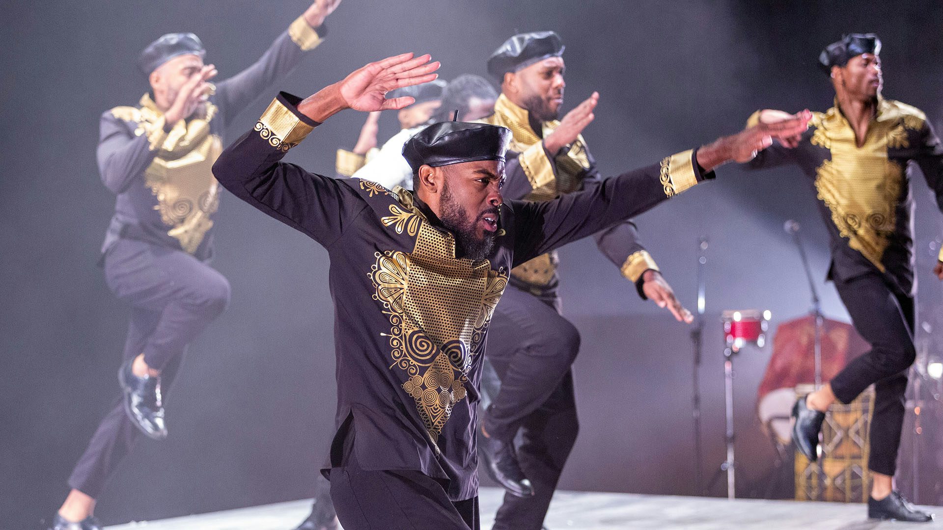 Dancers from Step Afrika! raise their arms in salute in a number from Stono.