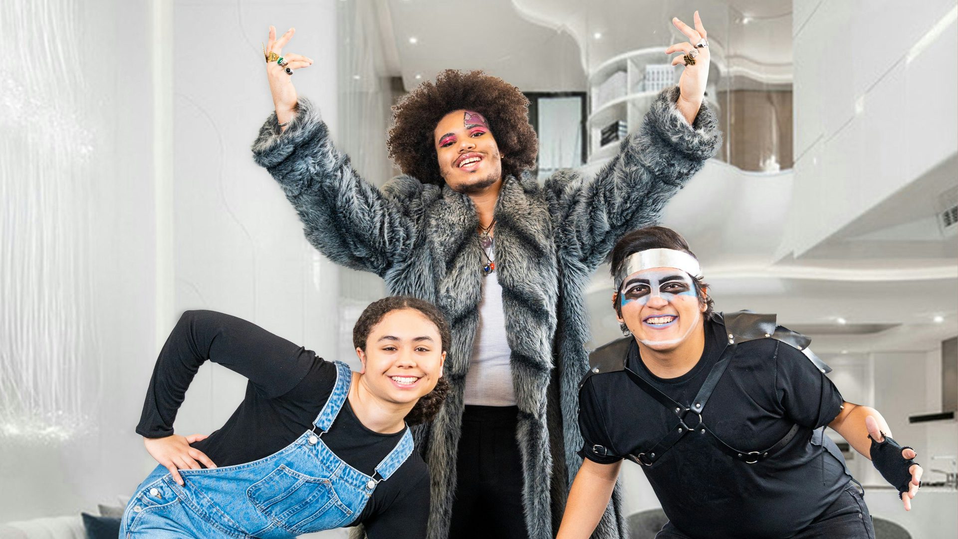 Cinderella, the prince and runka pose in front of a futuristic palace backrop.