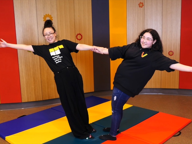 Mana and Keyleen pose in the one-armed counterbalance