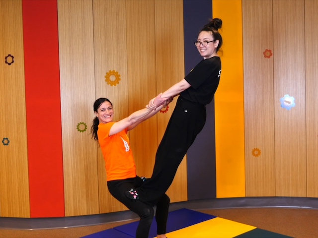 Gyana and Mana perform a standing thigh stand