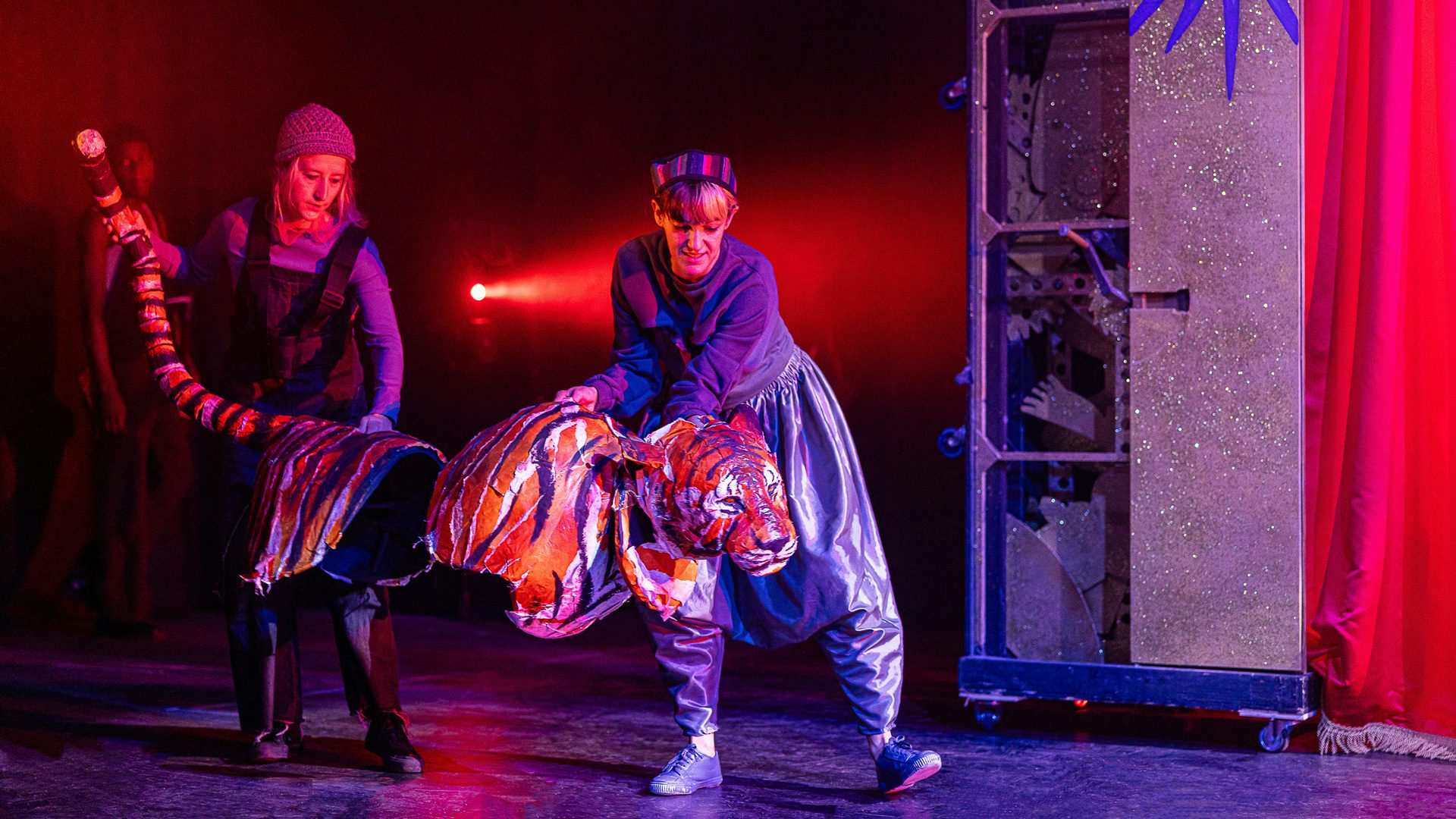 Lunging tiger puppet and puppeteers