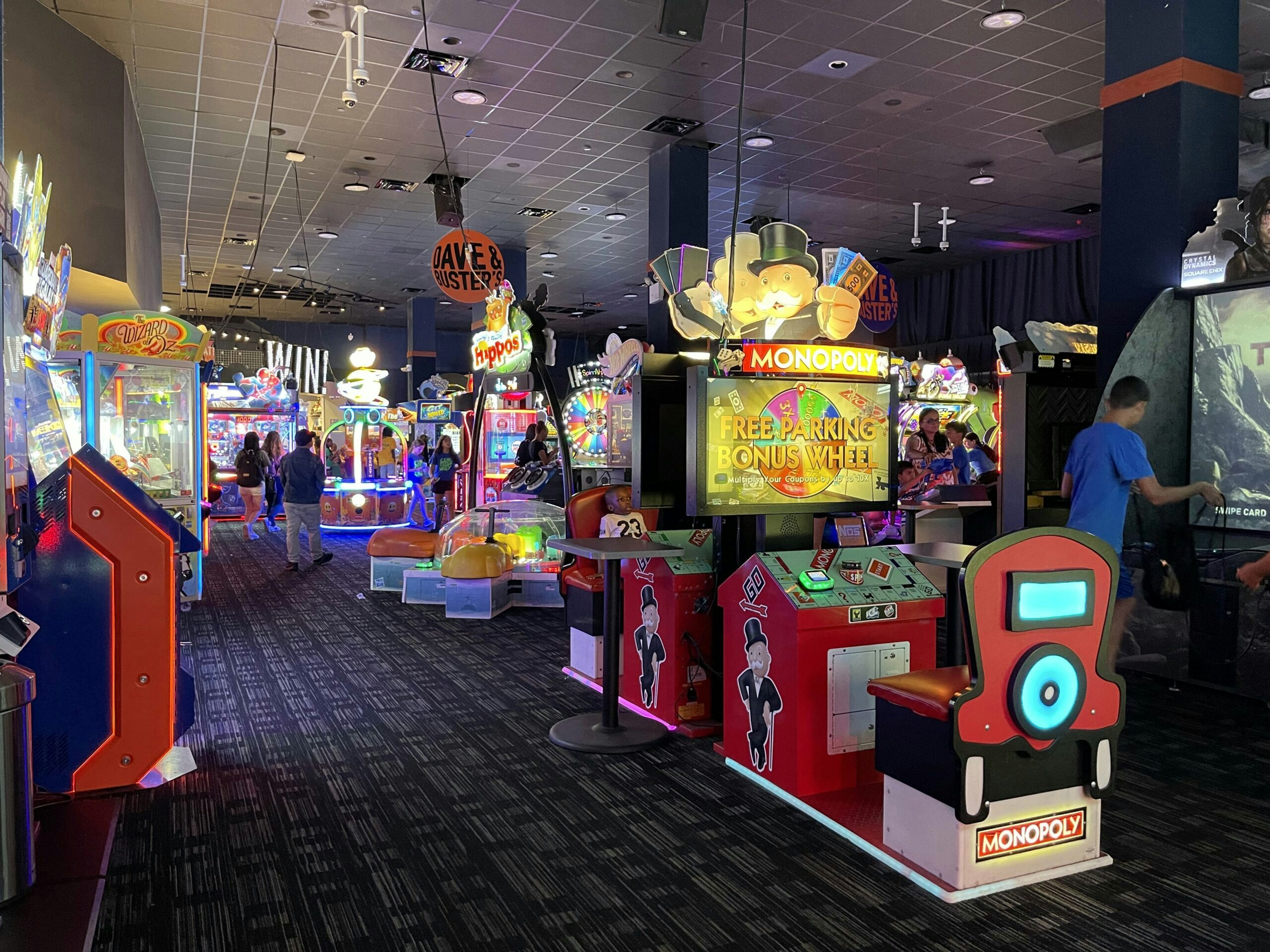 Interior of Dave & Buster's with many colorful, brightly-lit arcade games