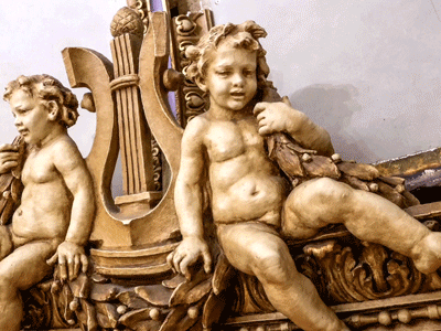 metal support spikes impaling plaster cherubs and lions on dome