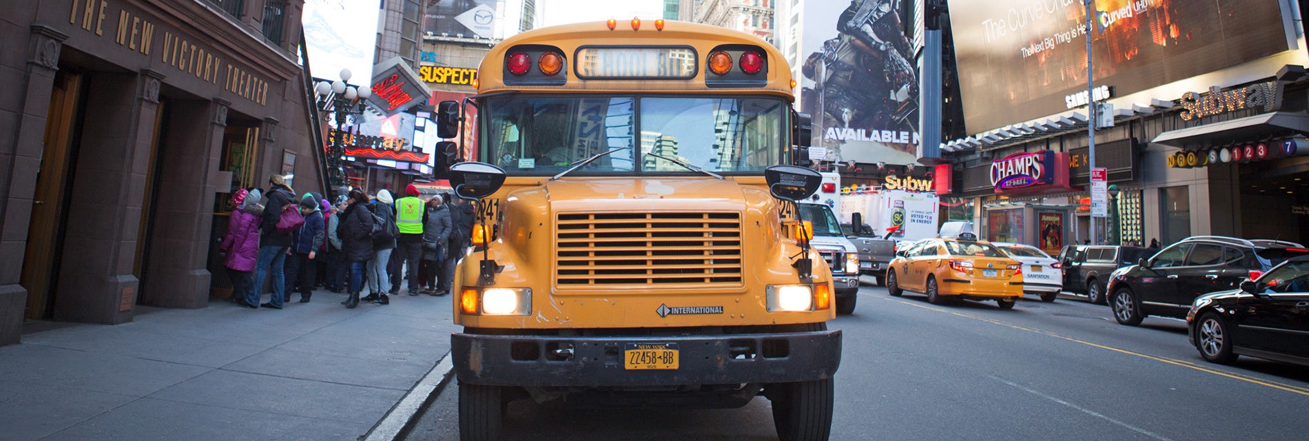 A school bus in front of the New Victory Theater