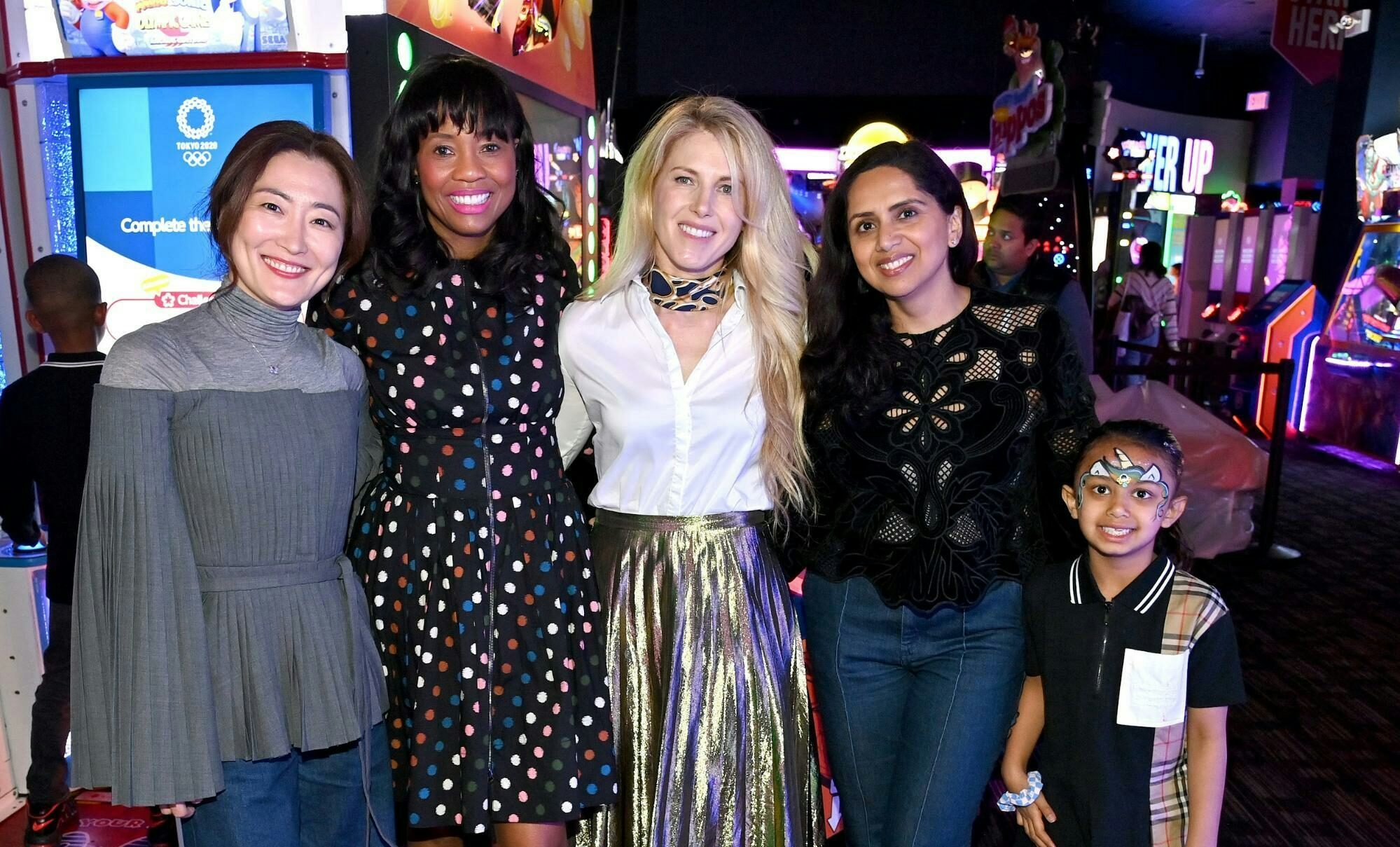 Four women and a child at dave and busters.