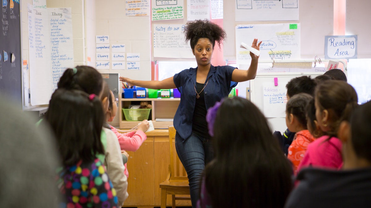 A teacher with her hands out to balance.