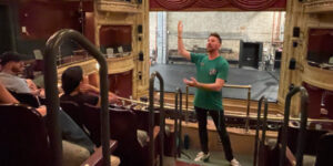 A guide giving a tour inside the new victory theater.