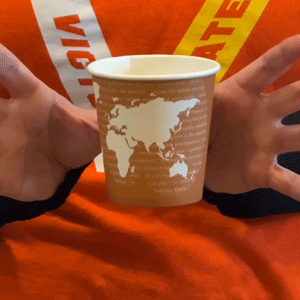 Looping GIF of the paper cup magically floating between Siobhan's wiggling fingers