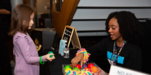 A New Victory usher helps a young patron at the Accessibility Table